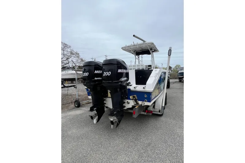 Slide: The Image of 2005 Angler 2700CC boat with dual Mercury 200 engines, parked on a trailer. - 4