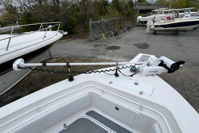 Slide: The Image of 2005 Angler 2700CC boat with Minn Kota trolling motor in a marina setting. - 9