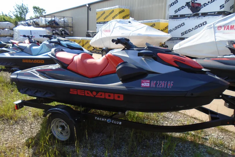 Slide: The Image of 2023 Sea-Doo GTI SE 130 jet ski on trailer, parked outdoors. - 2