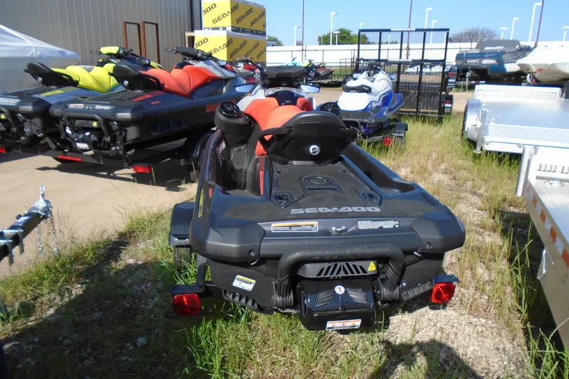 Slide: The Image of 2023 Sea-Doo GTI SE 130 jet skis displayed outdoors in a dealership lot. - 3