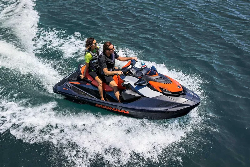 Slide: The Image of Manufacturer Provided Image: 2023 Sea-Doo GTI SE 130 jet ski with two riders on the water. - 6