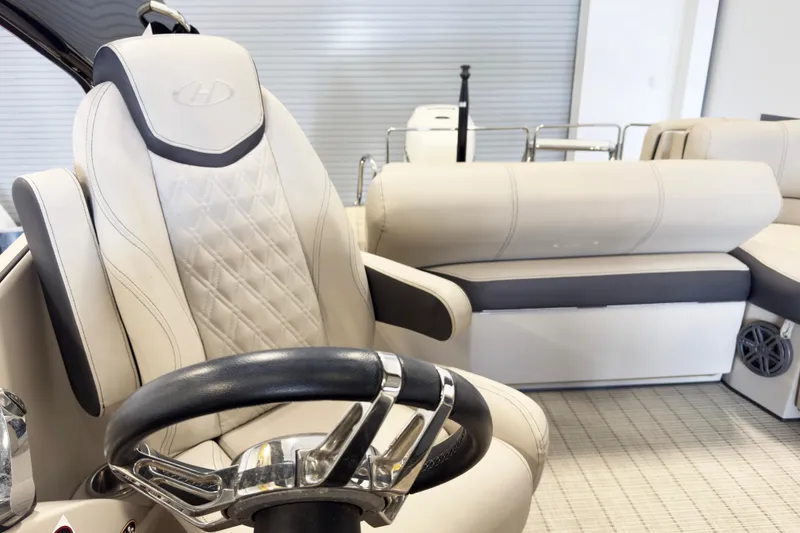 Slide: The Image of Luxurious interior of 2017 Harris Crowne 250 pontoon boat with plush seating and steering wheel. - 11