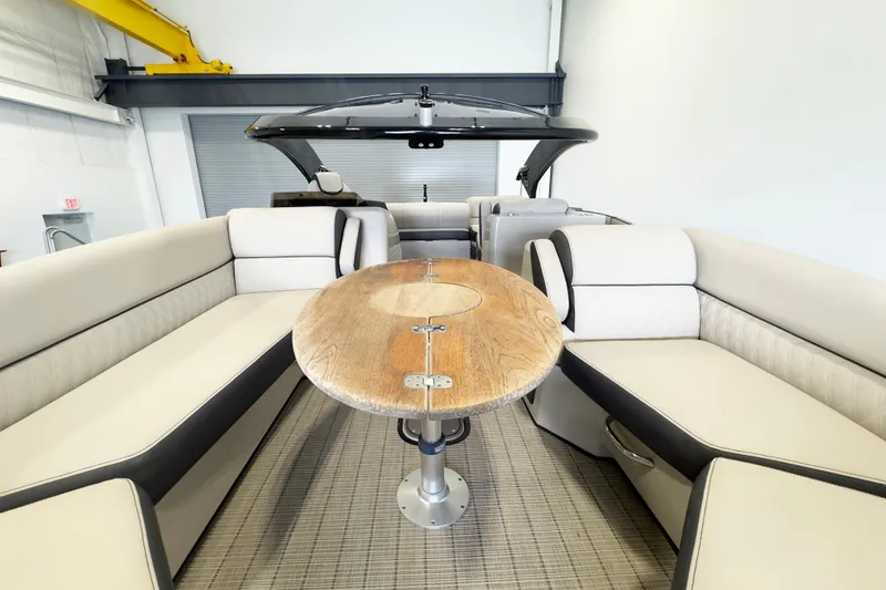 Slide: The Image of Luxurious interior of 2017 Harris Crowne 250 pontoon boat with elegant seating and wooden table. - 14