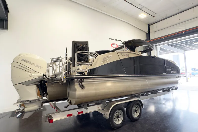 Slide: The Image of 2017 Harris Crowne 250 pontoon boat with Mercury engine on trailer in showroom. - 3