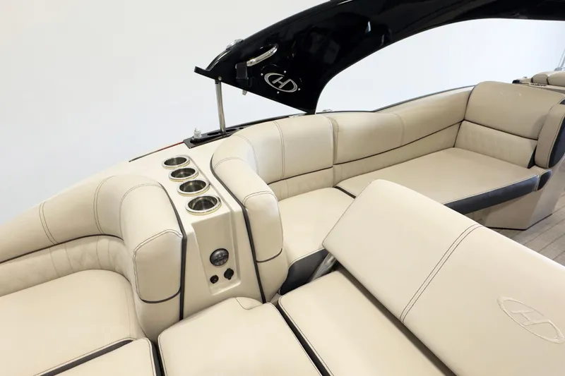 Slide: The Image of Luxurious interior of 2017 Harris Crowne 250 boat with beige seating and cup holders. - 7