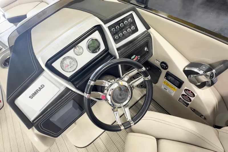 Slide: The Image of Helm of 2017 Harris Crowne 250 boat with steering wheel and control panel. - 9