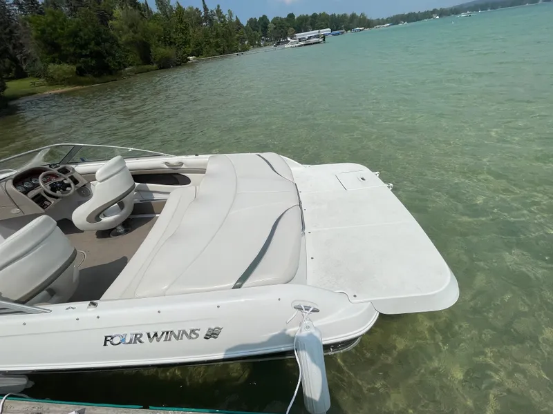 Slide: The Image of 2002 Four Winns 200 Horizon boat on clear lake water. - 3