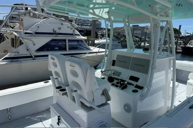 Slide: The Image of 2024 Contender 28 Tournament boat with modern helm console in marina. - 11