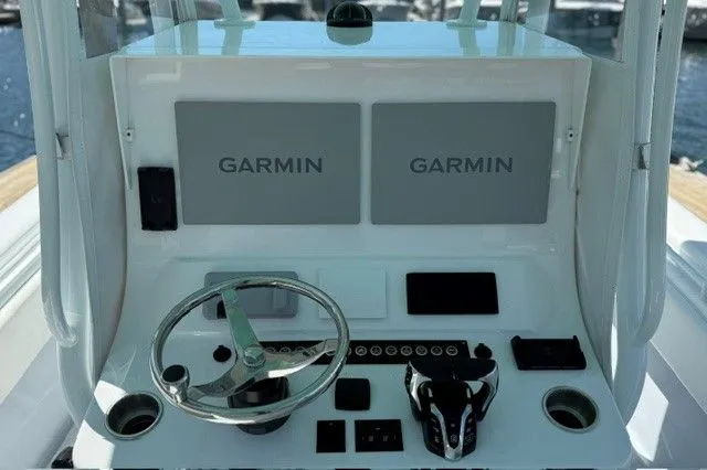 Slide: The Image of 2024 Contender 28 Tournament boat console with Garmin displays. - 13
