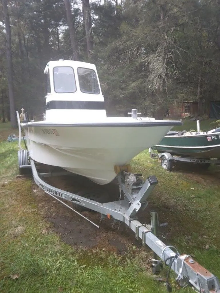 Slide: The Image of 2010 Maritime International Pioneer boat on trailer in forest setting. - 9
