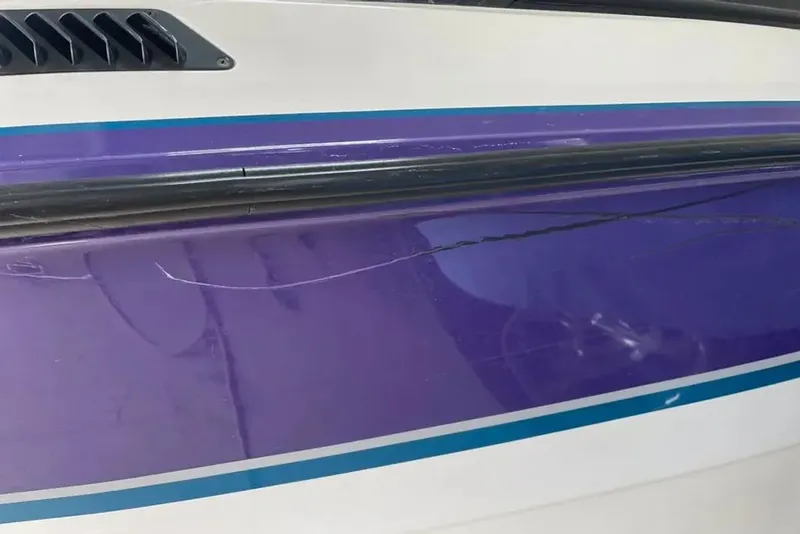 Slide: The Image of Close-up of a 1994 MasterCraft 205 Prostar boat hull with scratches. - 9