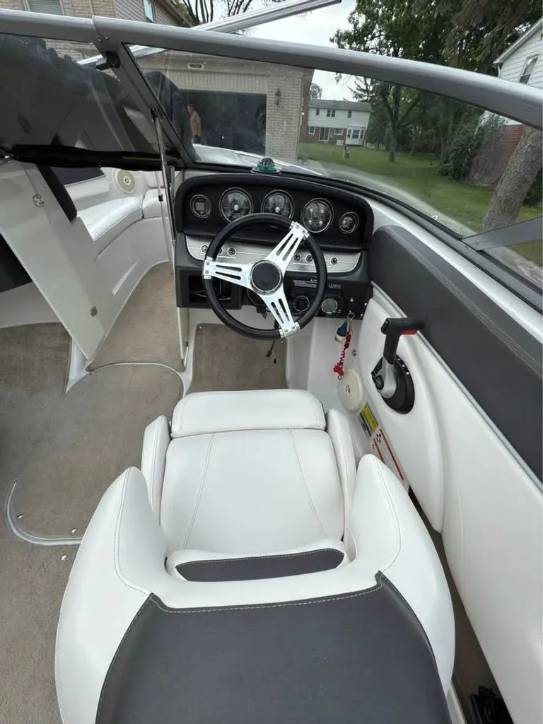 Slide: The Image of Interior of a 2010 Four Winns H210 boat with steering console. - 3