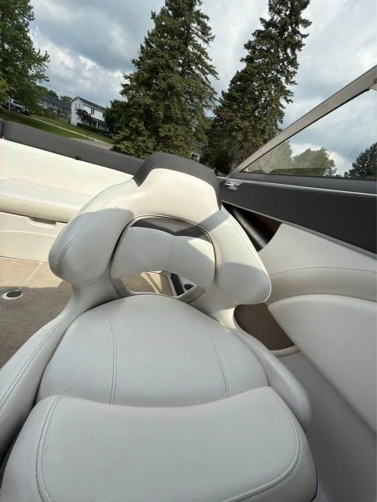 Slide: The Image of Interior of a 2010 Four Winns H210 boat with white seating. - 5