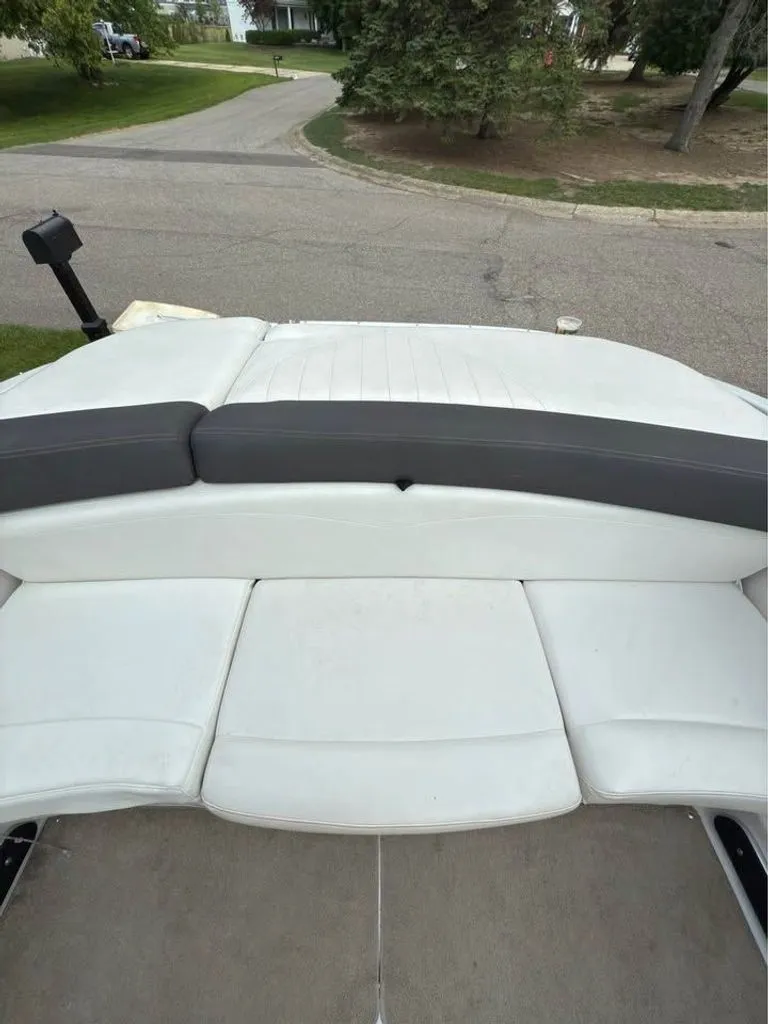 Slide: The Image of Rear seating of a 2010 Four Winns H210 boat on a street. - 7