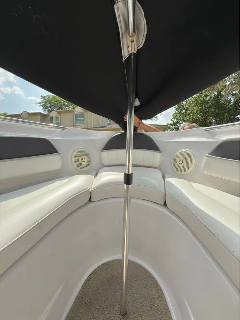 Slide: The Image of Interior view of a 2010 Four Winns H210 boat with seating area. - 8
