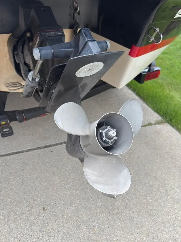 Slide: The Image of 2010 Four Winns H210 boat motor with propeller on concrete. - 9