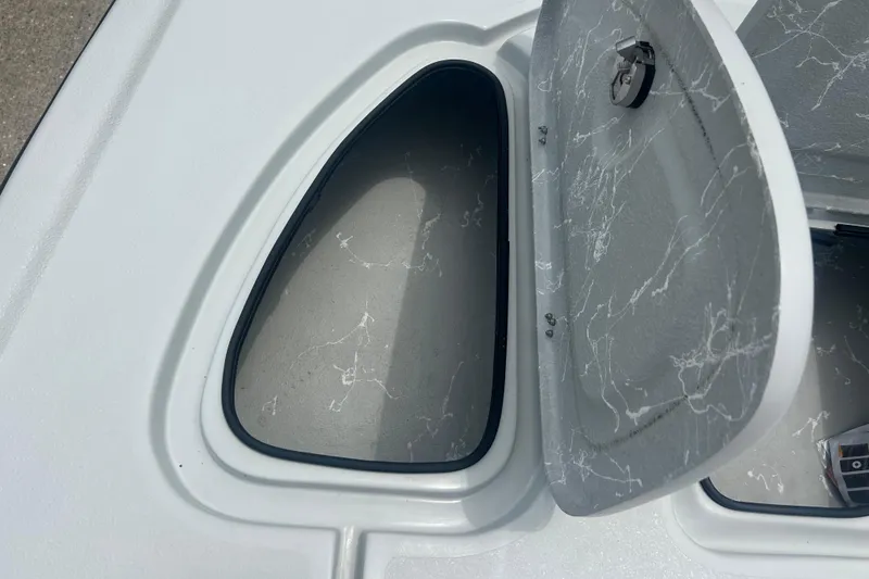 Slide: The Image of Open storage compartment on a 2025 Skuta 24 boat, featuring a sleek, modern design. - 12