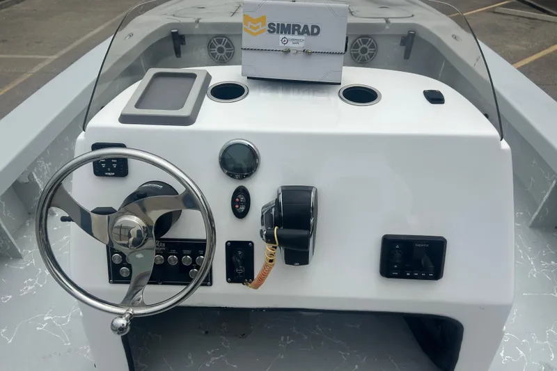 Slide: The Image of Steering console of 2025 Skuta 24 boat with Simrad electronics and modern controls. - 15