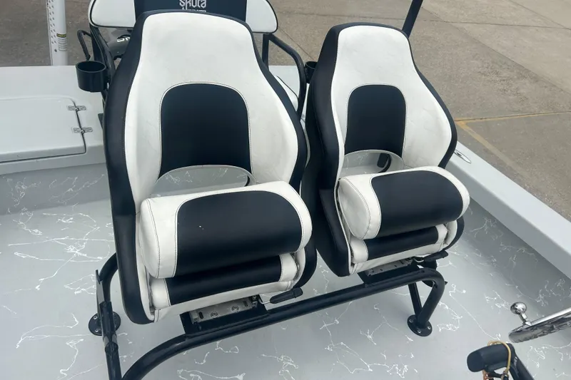 Slide: The Image of Dual black and white seats on a 2025 Skuta 24 boat deck. - 16