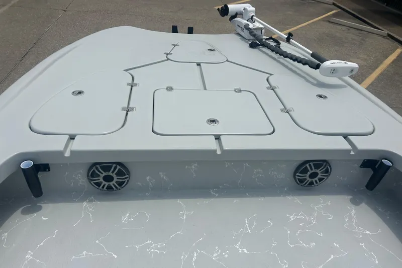 Slide: The Image of 2025 Skuta 24 boat deck with storage compartments and mounted trolling motor. - 7