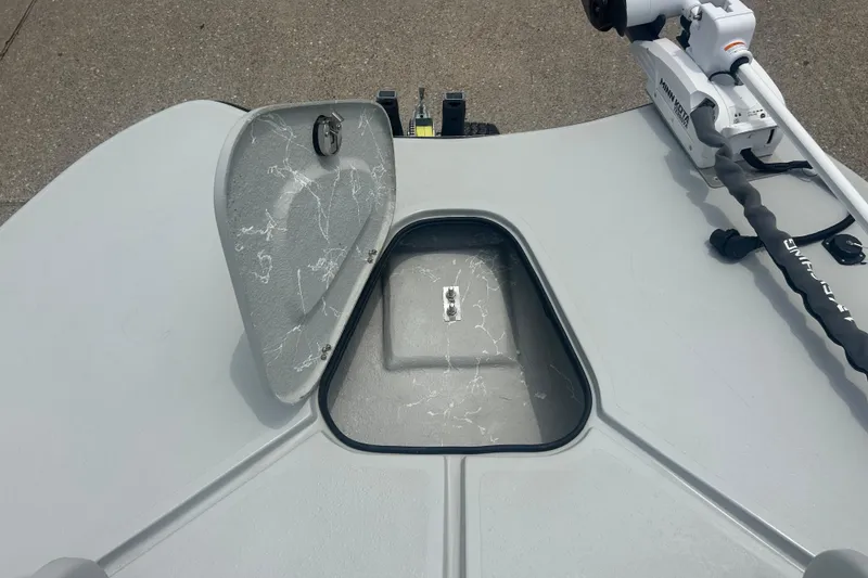 Slide: The Image of Open hatch on Skuta 24 boat deck, 2025 model, with visible storage compartment. - 9