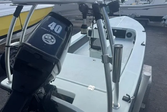 Slide: The Image of 2013 Ankona Native SUV boat with 40 HP outboard motor, docked in a marina. - 2