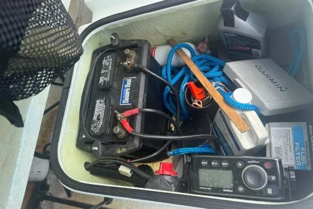Slide: The Image of Storage compartment of 2013 Ankona Native SUV with battery, tools, and equipment. - 3