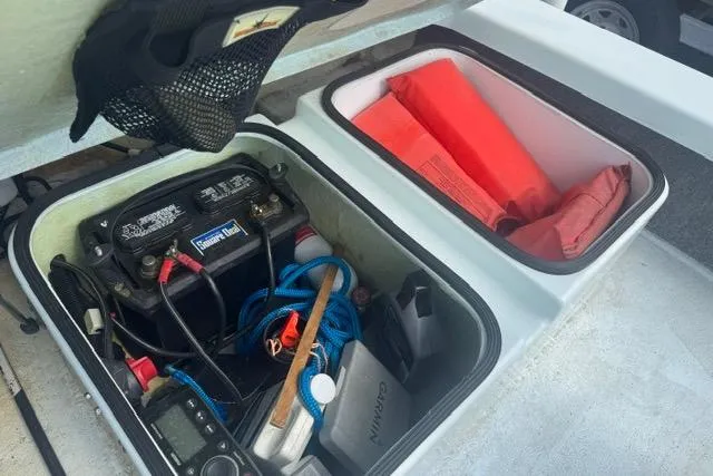 Slide: The Image of Storage compartments in a 2013 Ankona Native SUV, featuring a battery and safety gear. - 4