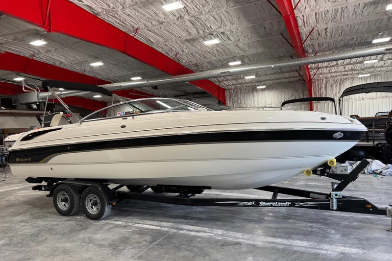 The Image of 2007 Bryant boat on trailer in indoor showroom with red ceiling beams. - 1