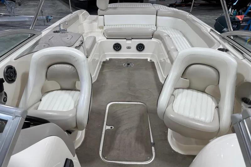 Slide: The Image of Interior of a 2007 Bryant boat featuring white seating and a compact sink area. - 10