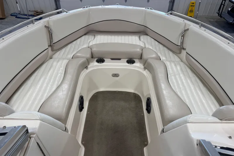Slide: The Image of 2007 Bryant boat interior with white cushioned seating and cup holders. - 11