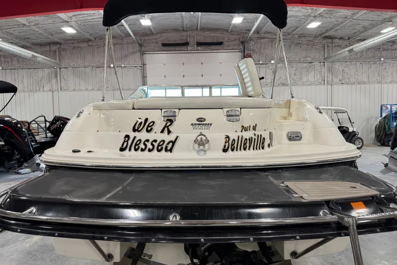 Slide: The Image of Rear view of a 2007 Bryant boat named "We R Blessed" in a storage facility. - 5