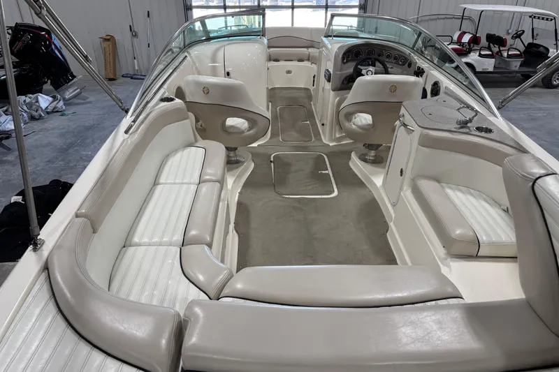 Slide: The Image of Interior of a 2007 Bryant boat with white seating and steering console. - 7
