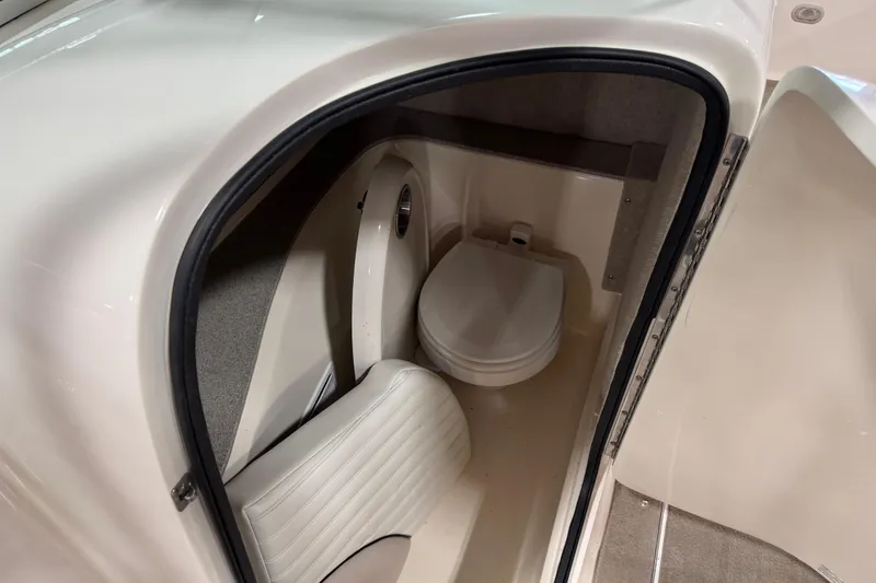 Slide: The Image of 2007 Bryant boat interior with compact marine toilet and seating area. - 9