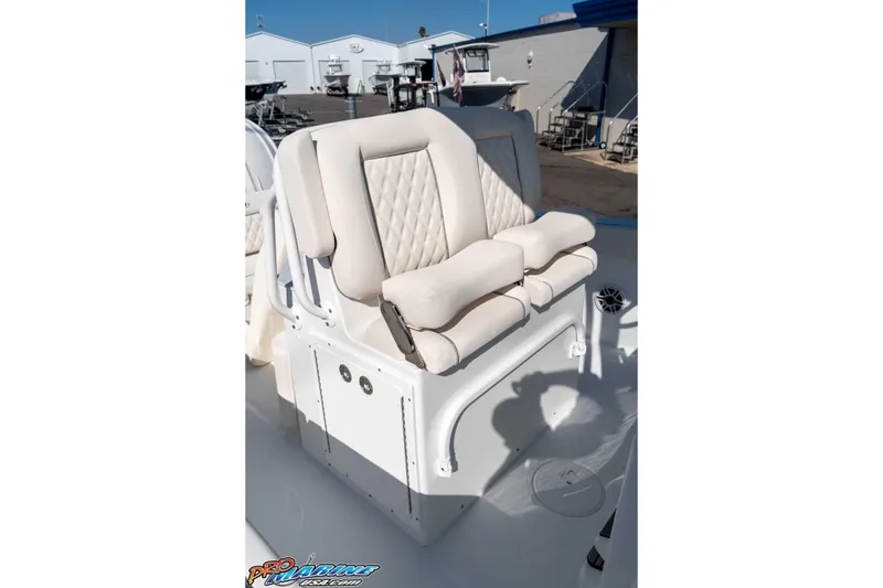Slide: The Image of 2026 Sea Hunt Ultra 265 SE boat seating with cushioned armrests in a marina setting. - 29
