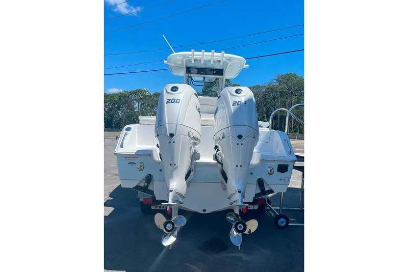 Slide: The Image of 2026 Sea Hunt Ultra 265 SE boat with dual 200 horsepower engines, parked outdoors. - 37