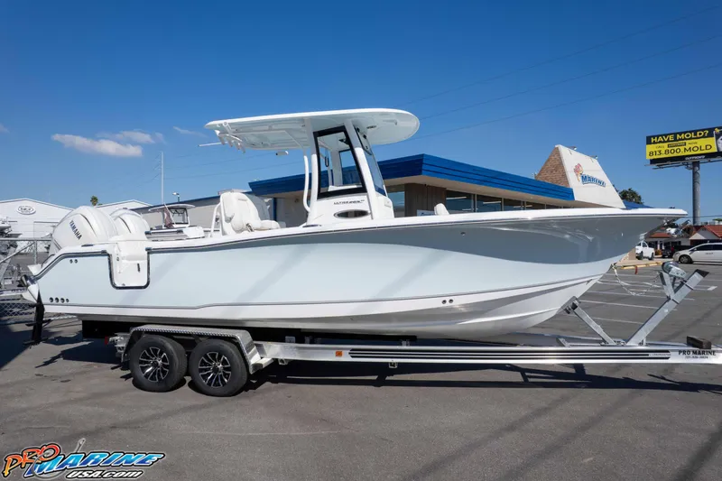 Slide: The Image of 2026 Sea Hunt Ultra 265 SE boat on trailer in dealership parking lot. - 4