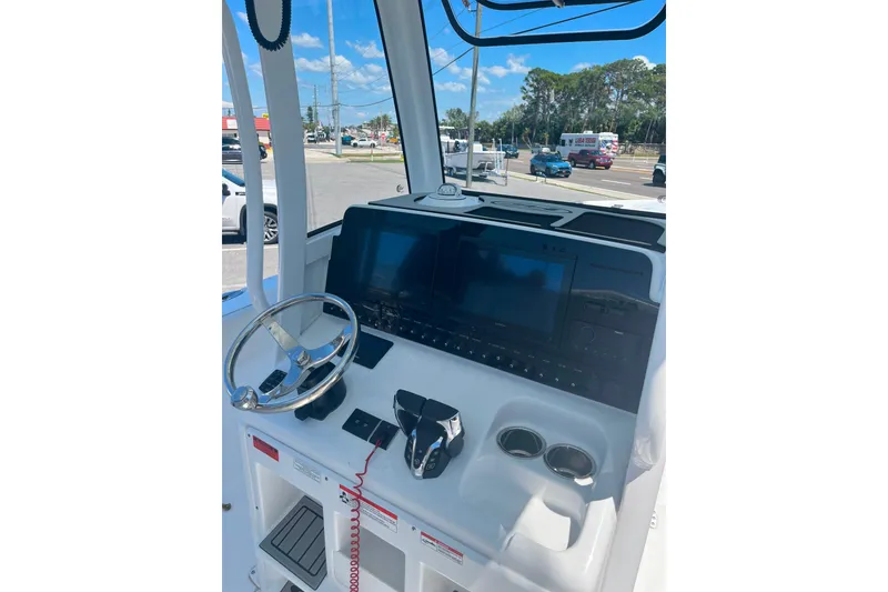 Slide: The Image of 2026 Sea Hunt Ultra 265 SE boat dashboard with steering wheel and modern controls. - 41