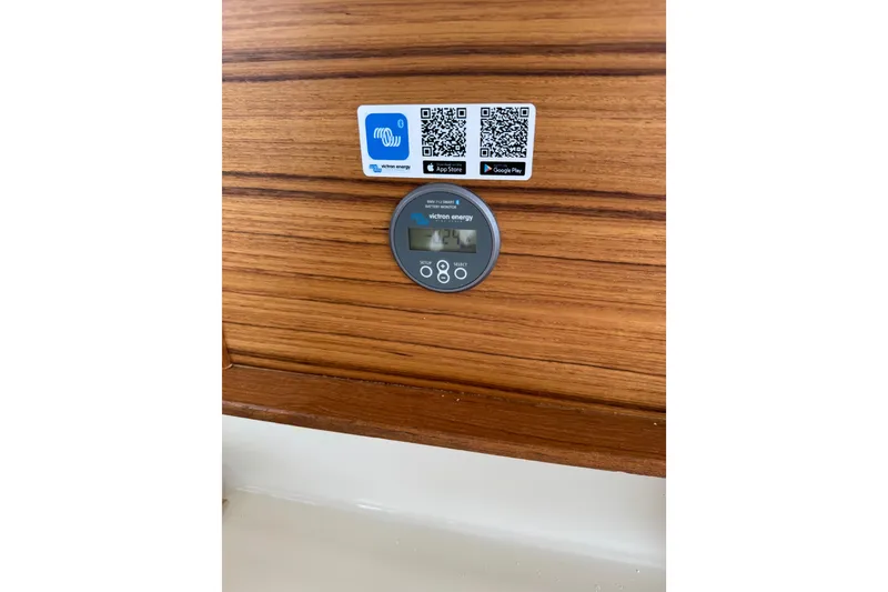 Slide: The Image of Control panel on 2026 Ranger Tugs R-25 boat with QR codes and Victron Energy display. - 28