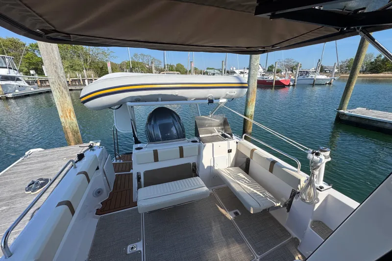 Slide: The Image of 2026 Ranger Tugs R-25 boat docked, featuring spacious deck and inflatable dinghy. - 8