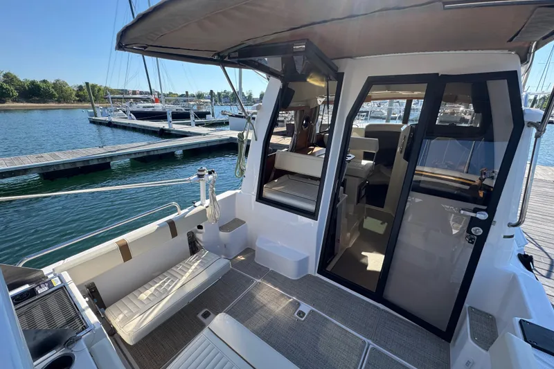 Slide: The Image of 2026 Ranger Tugs R-25 boat interior, docked at marina with open cabin door. - 9