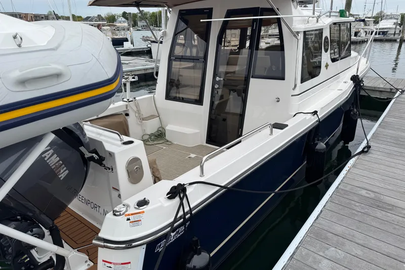 Slide: The Image of 2026 Ranger Tugs R-25 boat docked, featuring Yamaha outboard motor and sleek design. - 5