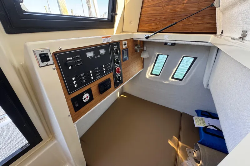 Slide: The Image of Interior cabin of 2026 Ranger Tugs R-25 with control panel and cozy seating. - 27