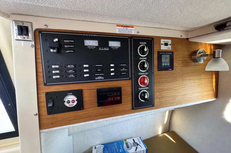 Slide: The Image of Control panel of 2026 Ranger Tugs R-25 boat with switches and gauges. - 26