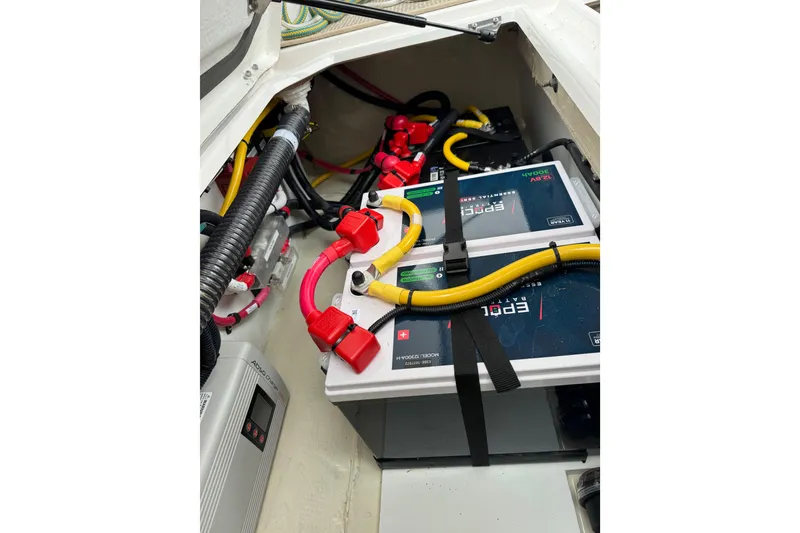 Slide: The Image of Battery compartment of 2026 Ranger Tugs R-25, featuring wiring and power connections. - 30