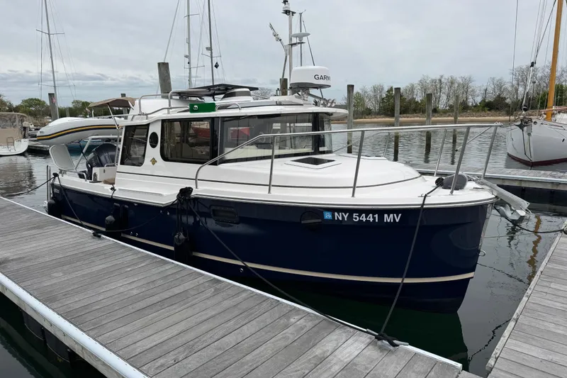 Slide: The Image of 2026 Ranger Tugs R-25 boat docked at marina, featuring sleek design and modern amenities. - 4