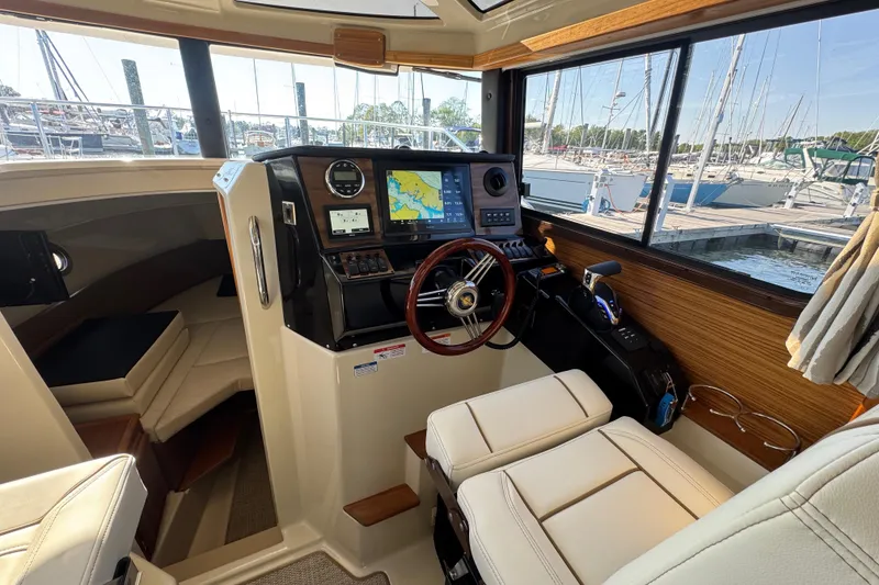 Slide: The Image of Interior of 2026 Ranger Tugs R-25 boat with modern navigation system and comfortable seating. - 14