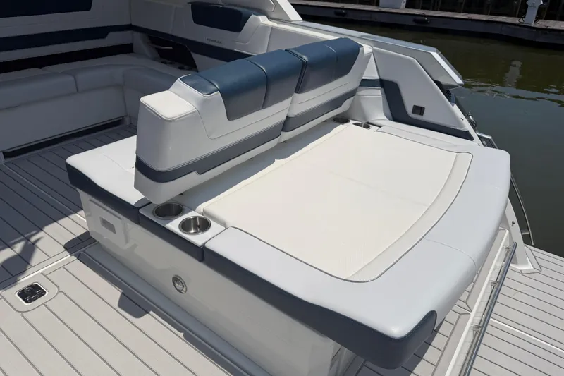 Slide: The Image of 2026 Formula 380 Super Sport Crossover OB boat interior with cushioned seating and cup holders. - 13