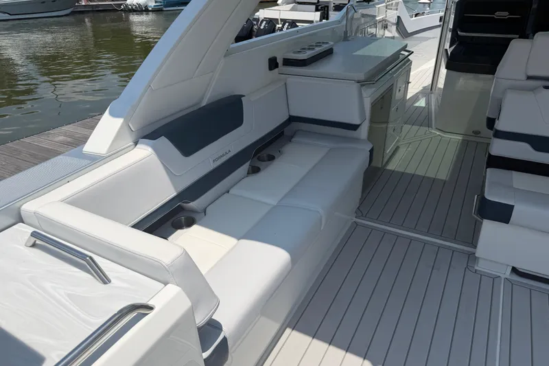 Slide: The Image of Luxurious interior of 2026 Formula 380 Super Sport Crossover OB boat, featuring sleek seating and cabinetry. - 15