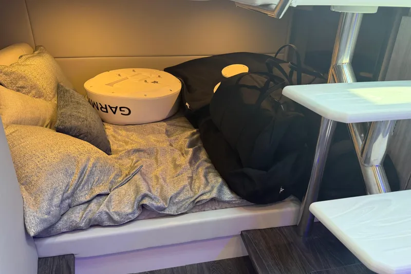 Slide: The Image of Cozy cabin interior of 2026 Formula 380 Super Sport Crossover OB with cushions and gear. - 32